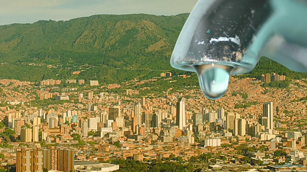 Gota de agua en un grifo sobre una vista panorámica de Medellín